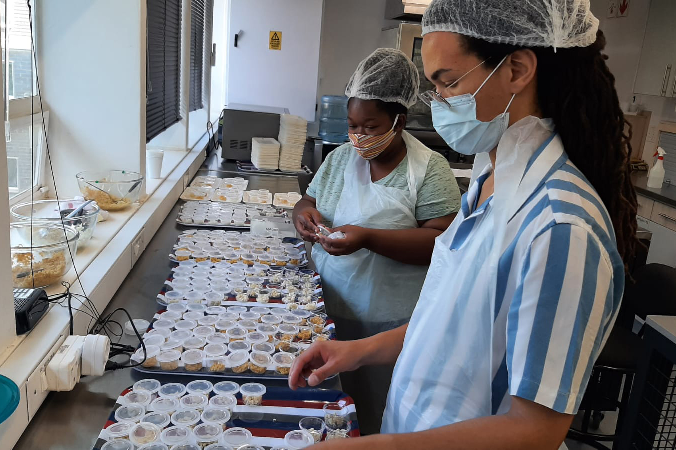 Taylon Colbert and Sisipho Rebe preparing samples for the tasting tests in the Sensory Lab.