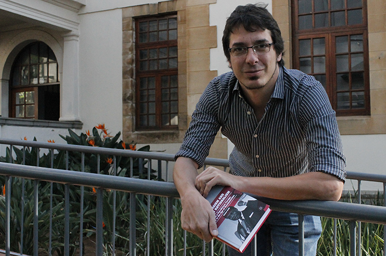 Dr Matteo Grilli with his first book in front of the North Block on the Bloemfontein Campus.