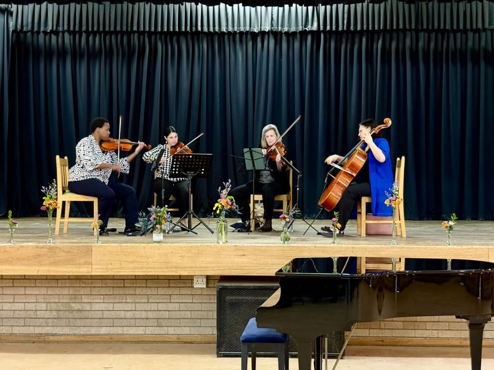 Members of the Odeion String Quartet working with young musicians