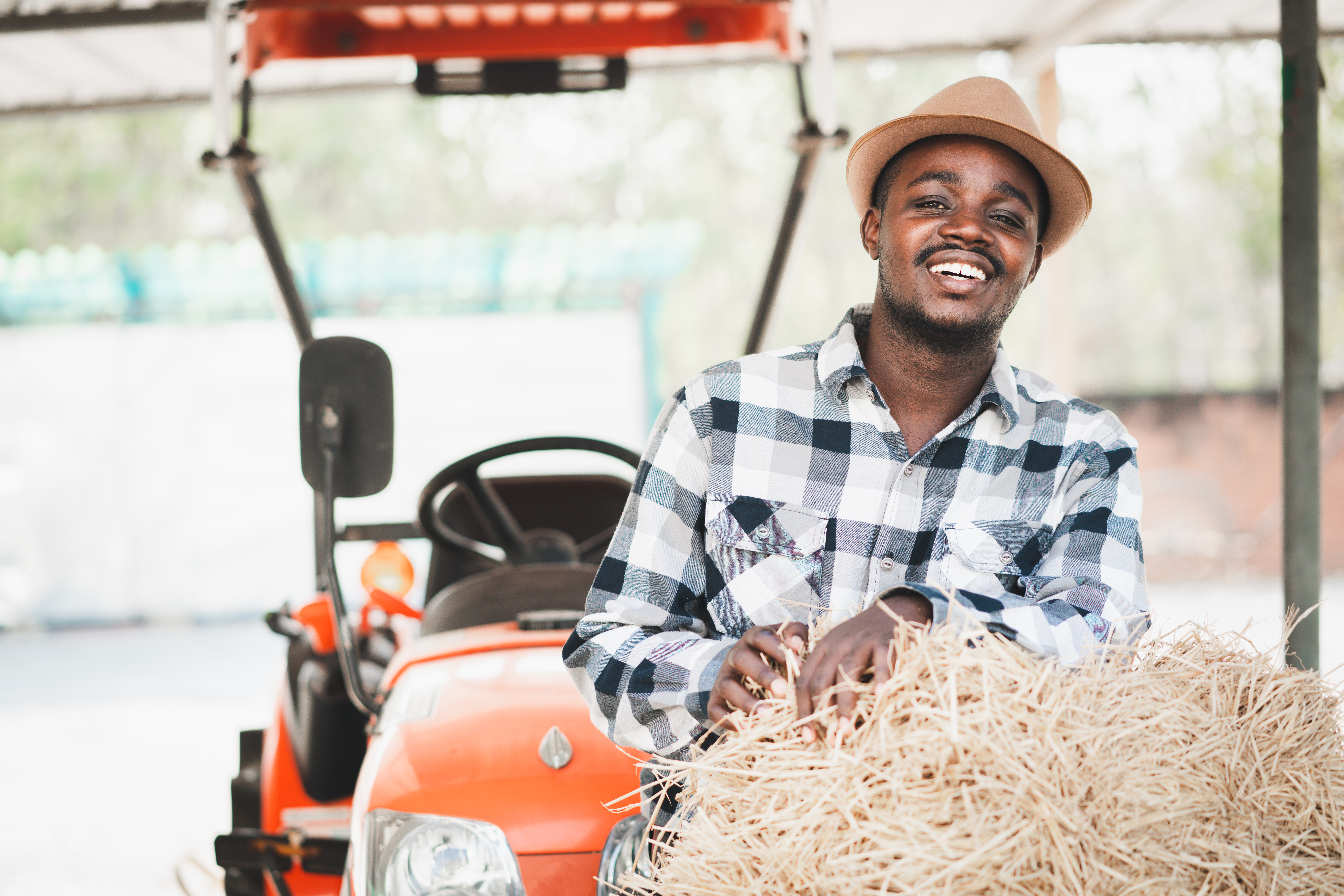 Farmer with tractor and hay bales