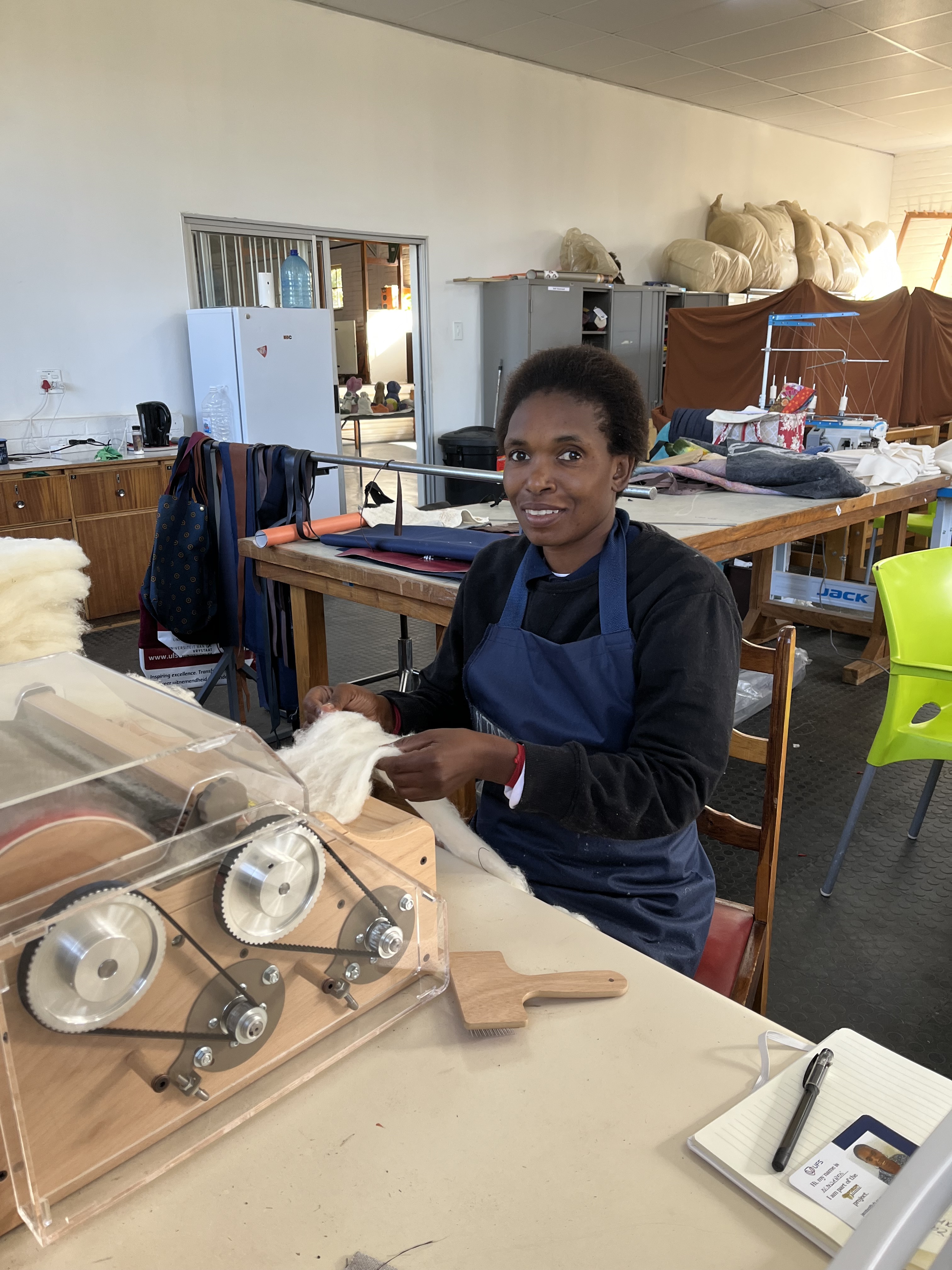 Ntabiseng Ndabeni is working on the carding machine