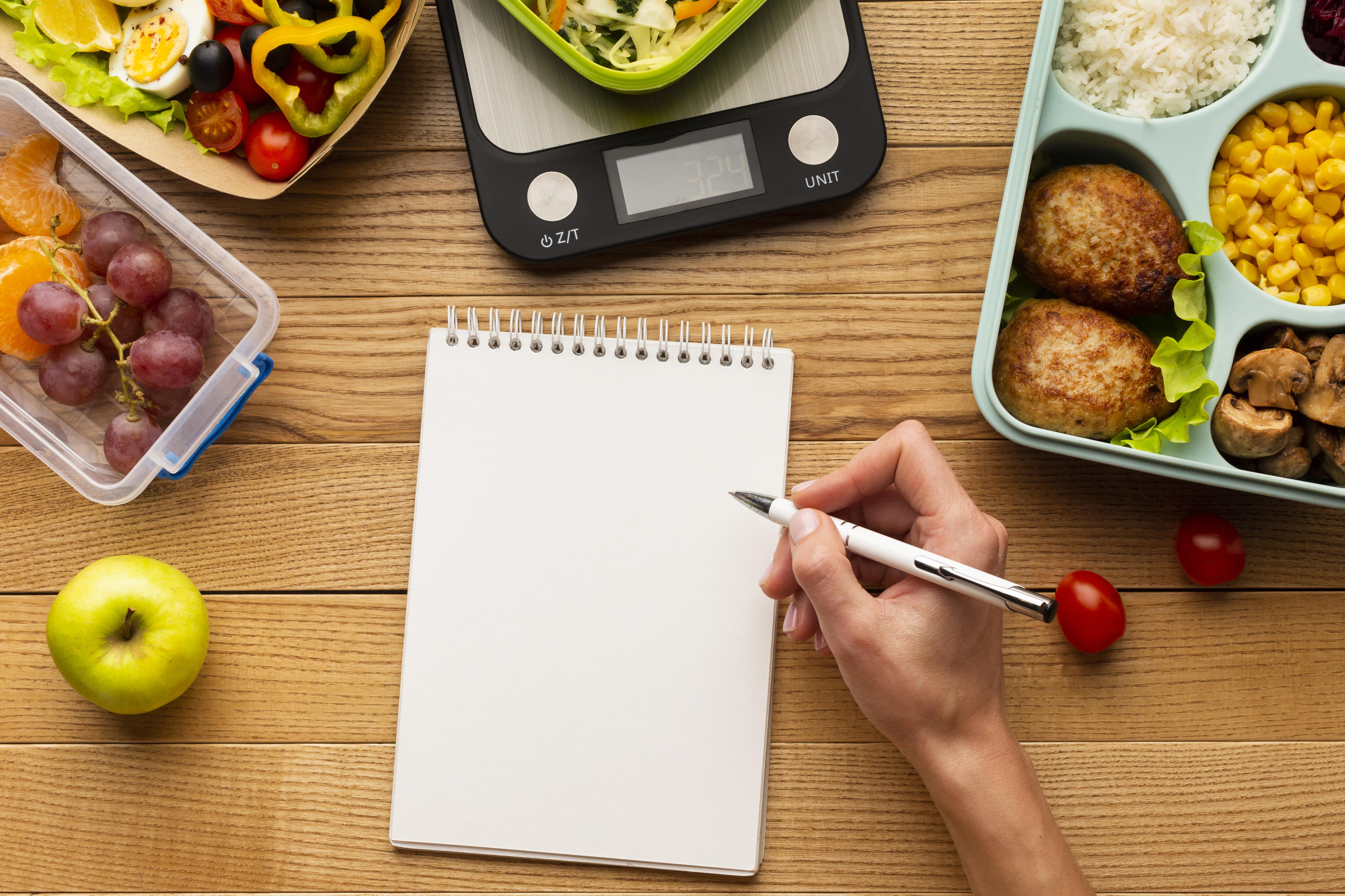 top-view-tasty-meal-arrangement-with-empty-notebook